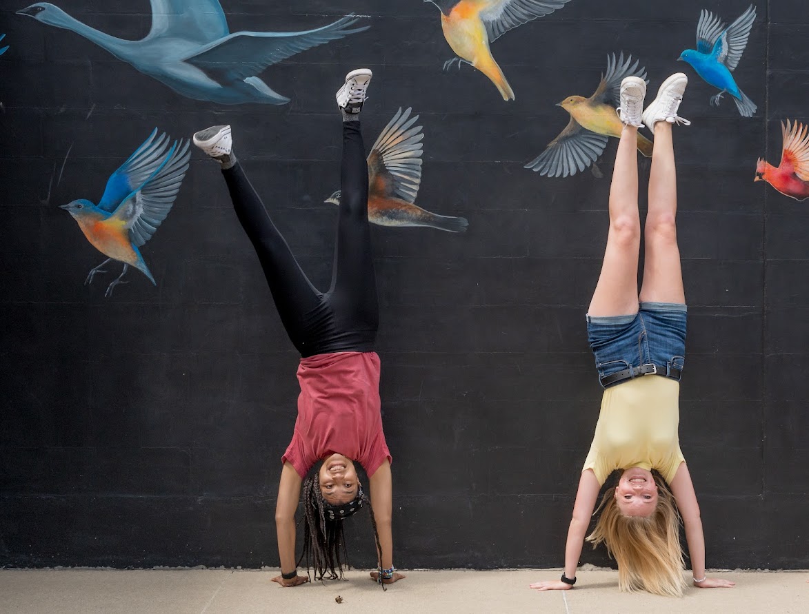 two girls doing handstands