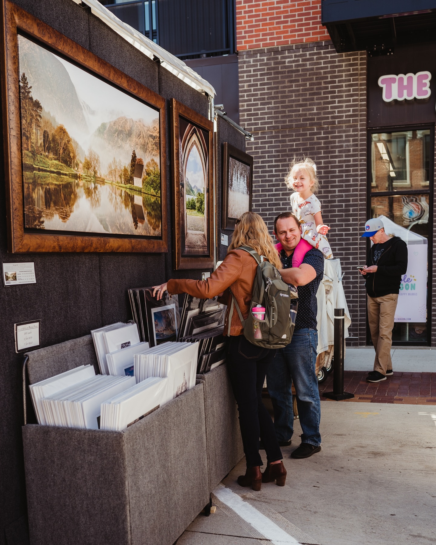 three people looking at art