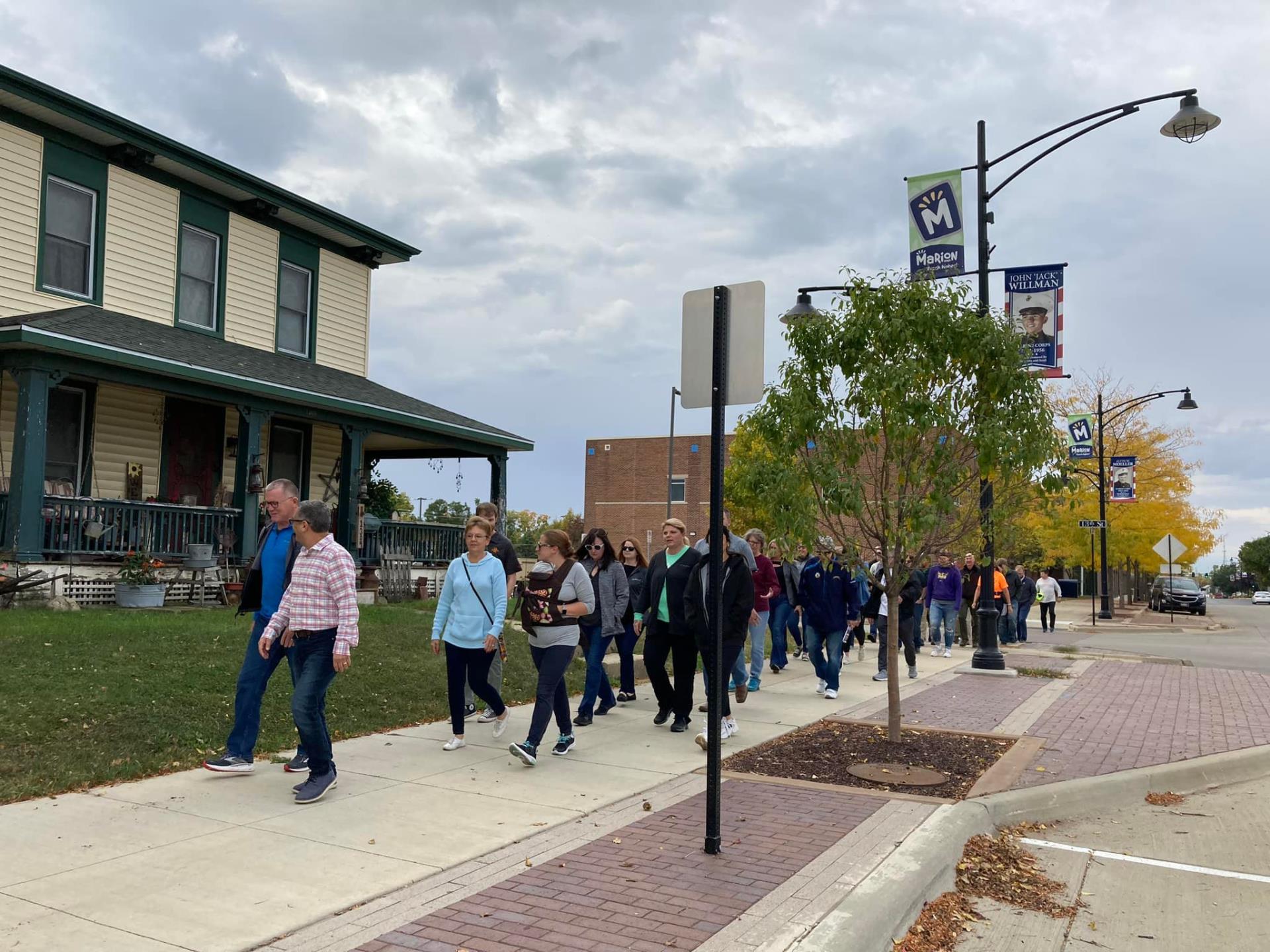 group of people walking on sidewalk